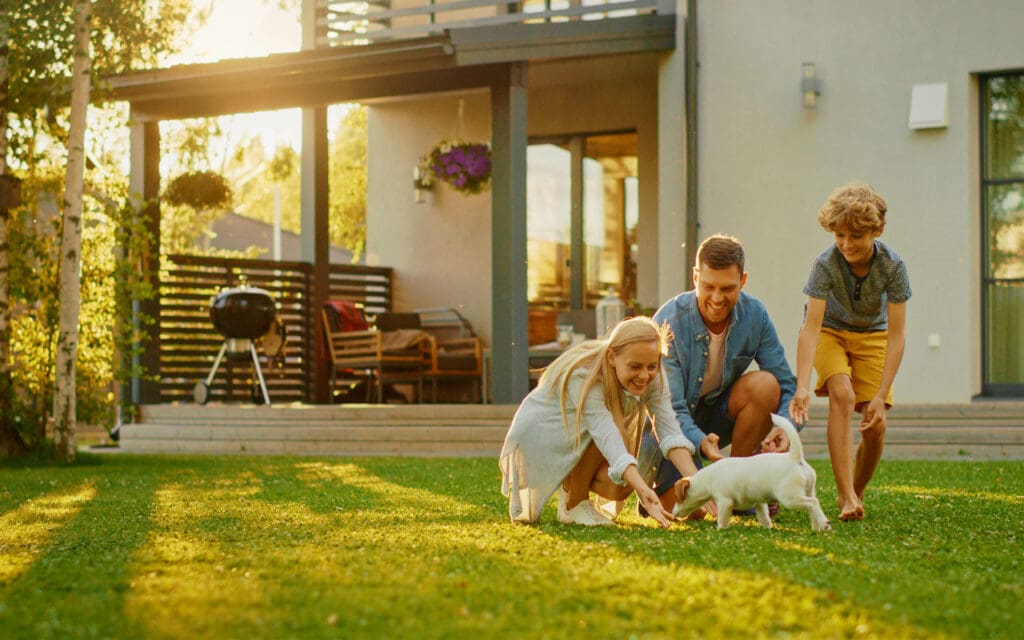 Custom-Landing-Page-Family-Outside-of-Their-Home-Grilling-and-Playing-with-the-Dog